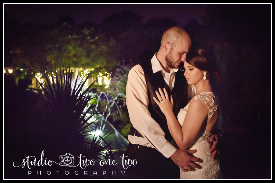 Bride and groom in gardens at night